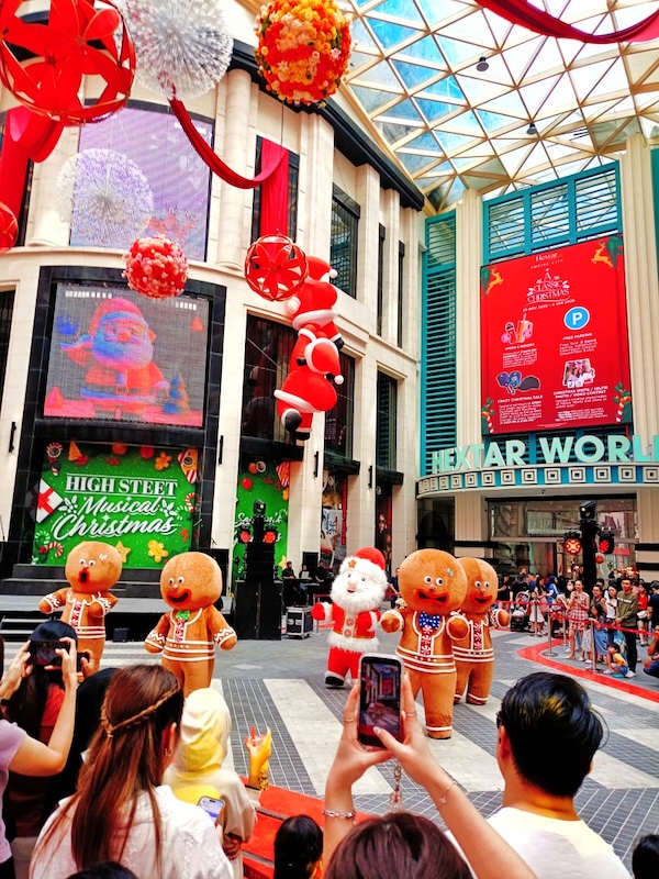 Visitors Gathering Around For The Gingerbread And Santa Mascot Dance Performance