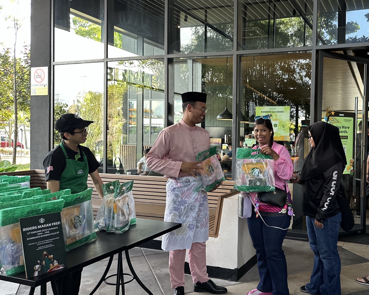 Starbucks Partner Passing Ramadan RTE Pack To Delivery Rider 1 Large